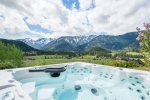 The outdoor  spa area serves exclusive captivating views of the mountains